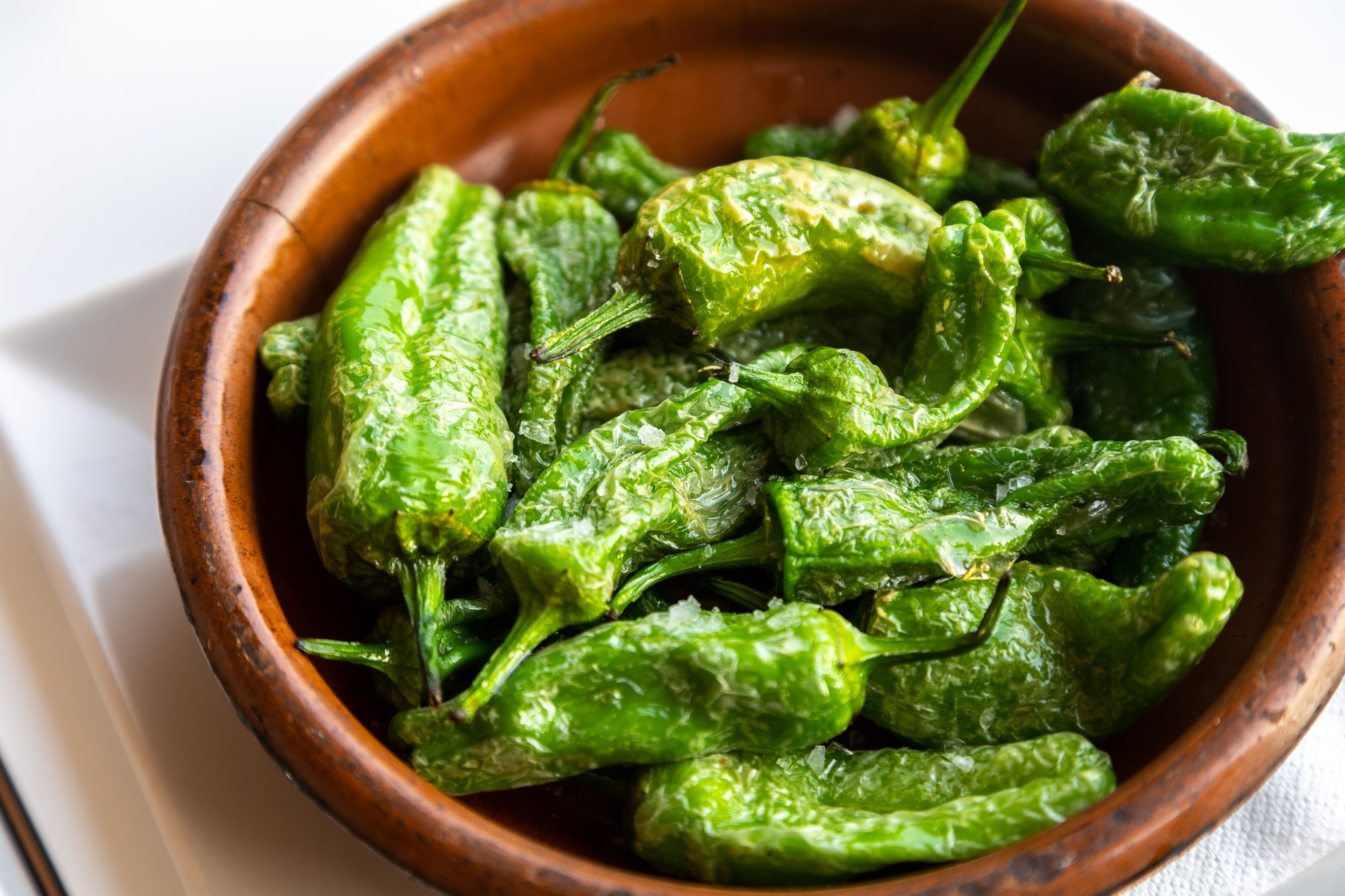 Closeup of the Padron peppers in the bowl.