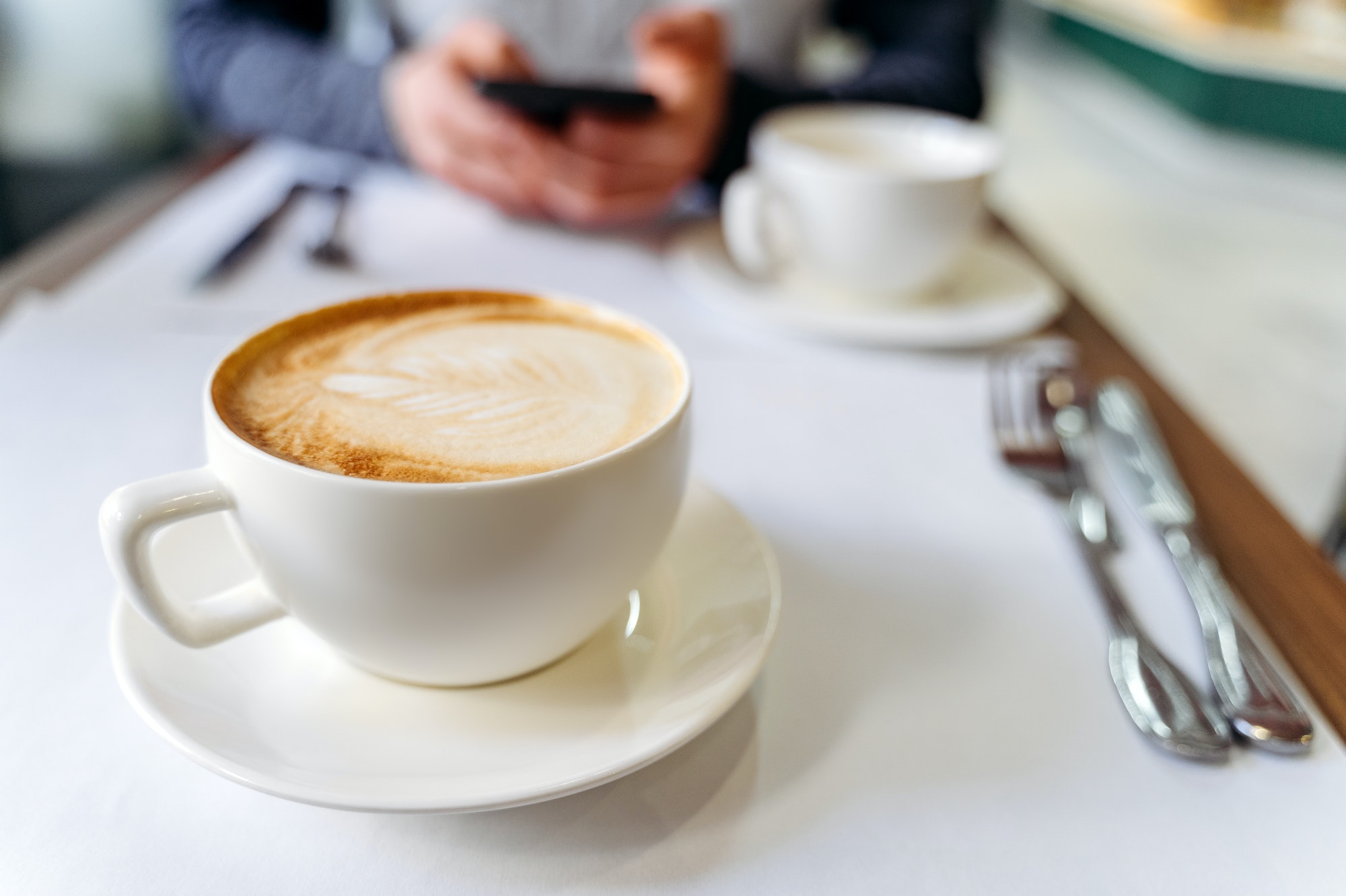 Cup with coffee on the table in a coffee shop.