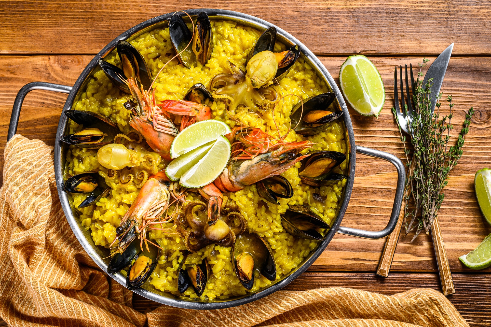 Seafood paella in the fry pan with prawns, shrimps, octopus and mussels